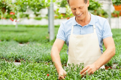 Gardener wearing protective equipment while pruning shrubs
